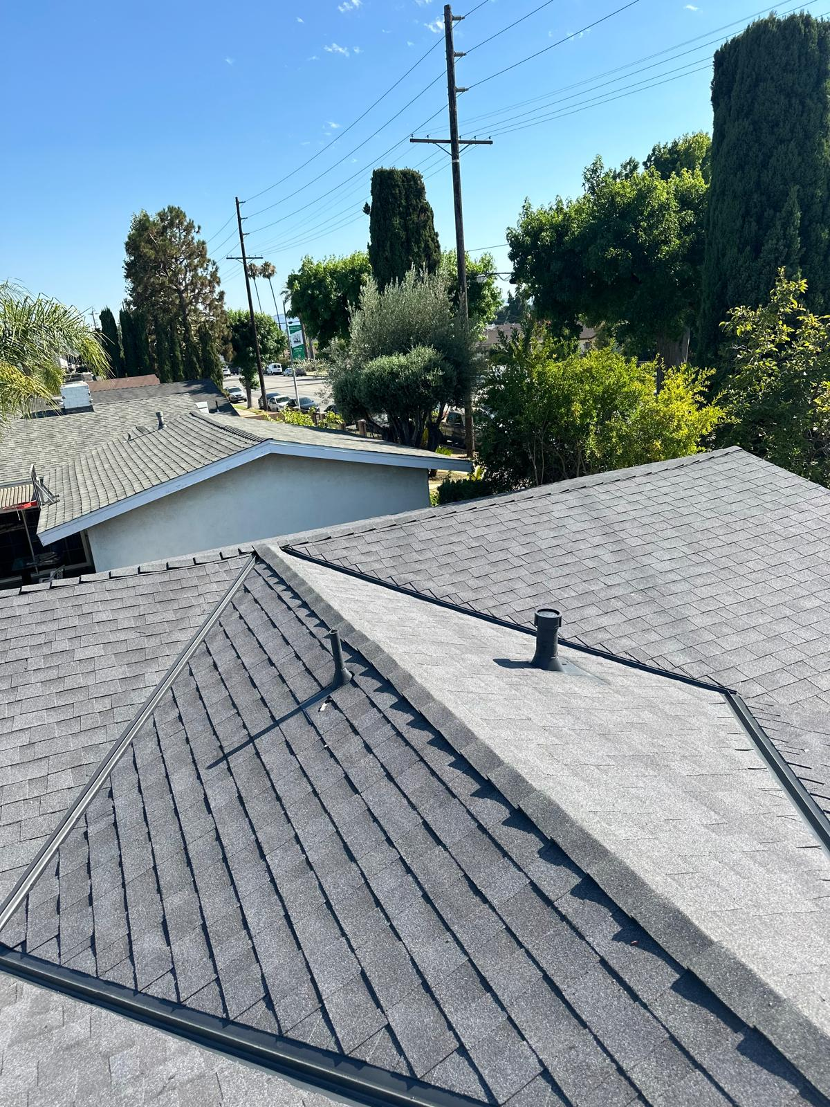 Gray asphalt shingle roof with ridge vents