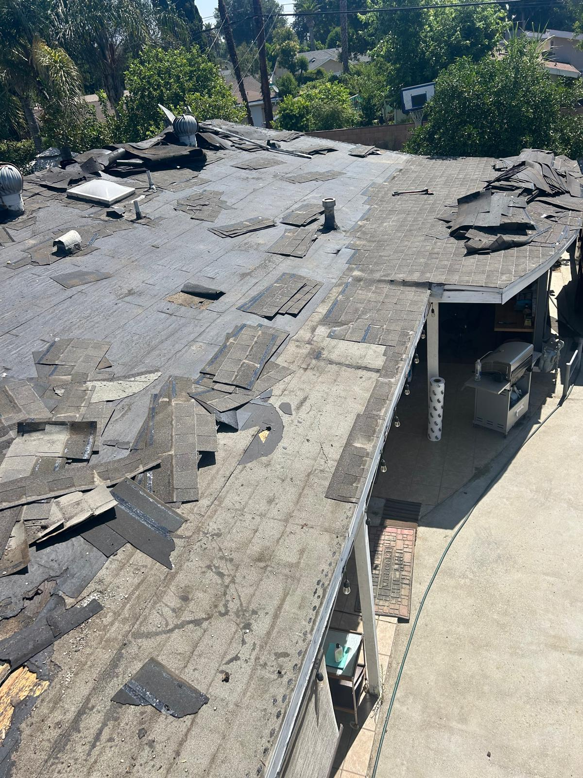 Roof tear-off and shingle removal in progress